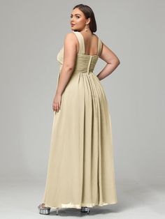 a woman in a beige dress with her back to the camera