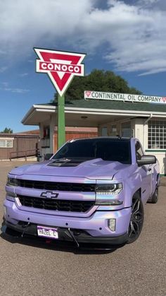 a purple truck parked in front of a building