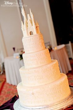 a large white wedding cake sitting on top of a table