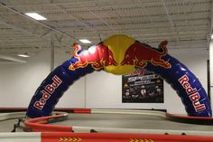 an inflatable red bull sign is on display