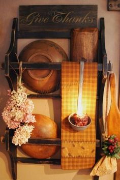 a wall mounted shelf with various items on it and a lit candle in the middle