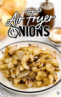 an air fryer onion on a white plate next to sliced onions and bread slices