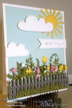 a card with flowers and clouds on it