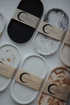 several different types of plates with labels on them sitting next to each other in front of a white table