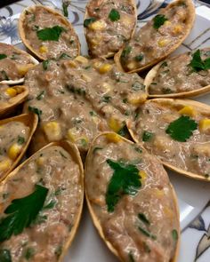 an arrangement of shells filled with food on a plate