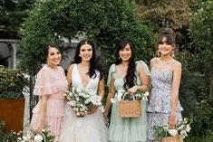 the bridesmaids are all dressed in pastel dresses