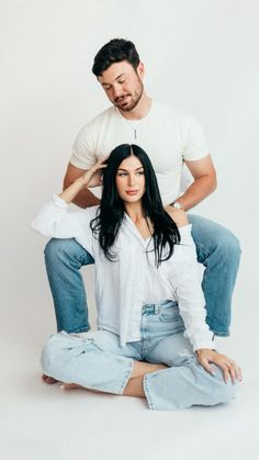 a man sitting on top of a woman's head