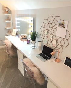 a white desk topped with a laptop computer