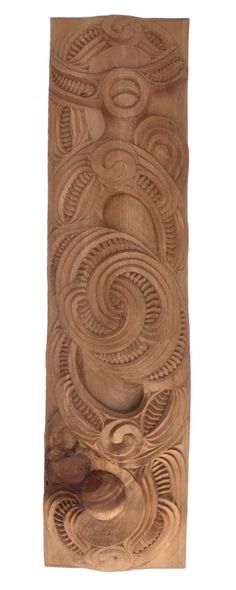 an intricate carved wooden panel with swirls and circles