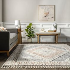 a living room with two couches and a rug on the floor in front of it