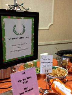 a table topped with plates and bowls of food next to a sign that says verdde vie