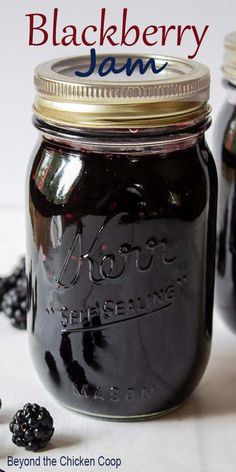 blackberry jam in a mason jar with blackberries around it