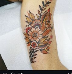 a woman's leg with a flower tattoo on it