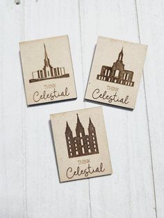 three wooden coasters with the words think celestial on them and a clock tower in the background