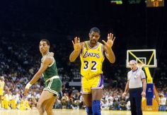 two basketball players are playing on the court