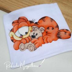 a white t - shirt with an orange tiger and a brown teddy bear on it