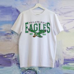 Unisex Short Sleeve Tee - Materials: 100% Cotton. Otton Medium-Heavy Fabric (8.0 Oz/Yd (271.25 G/M)) - Size: S,M,L, Xl, 2xl - Cloose Fit - Sewn In Label - Runs True To Size Eagles Gear, Eagles Shirt, Eagles Jersey, Football Tee, Football Tees, School Shirts, Unisex Shorts, Football Shirts, School Design