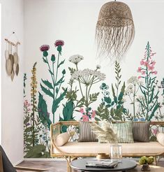 a living room with flowers and plants painted on the wall