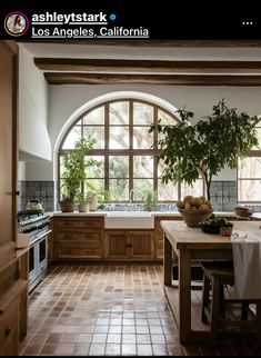 a kitchen with an arched window and tile flooring is shown in this advertisement for the los angeles california home magazine