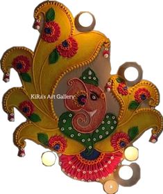 an intricately decorated wall hanging with candles and flowers on it's face, in yellow