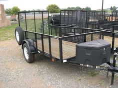 a trailer that is sitting in the dirt with two side by side trailers attached to it