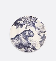 a blue and white plate with a tiger on it