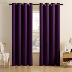 the purple curtains in this room are ready to be hung