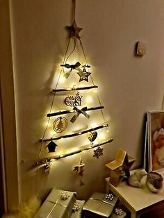 a christmas tree made out of lights in the corner of a room next to a dresser