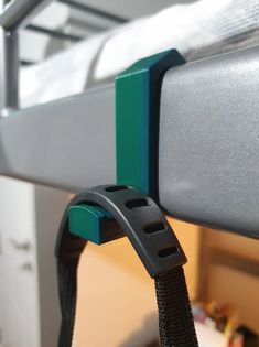 a close up of a metal bed frame with a black and green cord attached to it