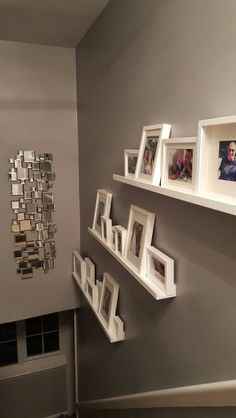 there are many frames on the wall with pictures