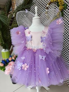 -It is made of lilac tulle and pink satin fabric and decorated with pearls. The butterfly and flower objects on it add elegance to the dress. - The materials used are based on quality and child health. -The costume is prepared after the order, in line with customer requests. -It is prepared specifically for you in the colors and sizes you want. SHIPPING - The costume is prepared specifically for the person after ordering. For this reason, normal delivery time is maximum 10 days. PERSONALIZABLE -The changes you want can be made. You ask, we will prepare it specially for you. It is prepared either in standard sizes or in the sizes you provide. Please contact us for your requests. NOTE It will add elegance to your daughter at many special moments such as birthdays, weddings, costume parties, Butterfly Wings Costume, Pink Satin Fabric, Normal Delivery, Twin Halloween, Wings Costume, Butterfly Dress, Kids Health, Summer Parties, Pink Satin