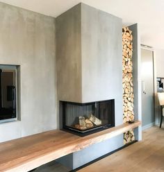 a living room with a fire place next to a wall mounted tv on a wooden shelf