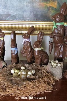 chocolate easter bunnies and eggs in front of a painting