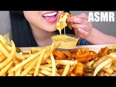 a woman is eating french fries and dipping sauce on them