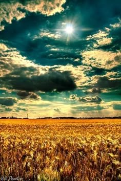 the sun shines brightly through clouds over a wheat field in this artistic photo by person