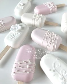 there are many pink and white ice creams on sticks