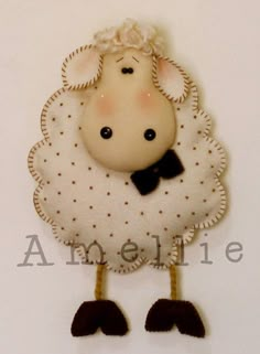 a white sheep with a black bow tie hanging from it's side on a wall