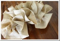 an origami flower made out of old book pages