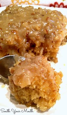 a close up of a piece of cake on a plate with a spoon in it