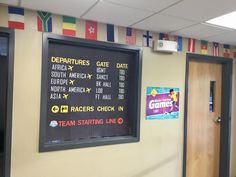 a menu board on the wall in a restaurant with flags hanging from it's walls