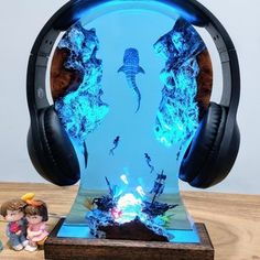 headphones are sitting on top of a table with an image of jellyfish in the water