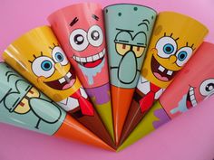 five different colored cartoon character paper fans on a pink background