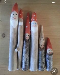 seven wooden gnomes are lined up in a row