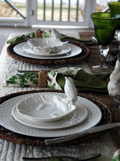 the table is set with dishes and place settings