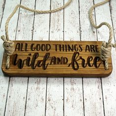 a wooden sign that says all good things are wild and free