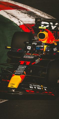 a red and yellow race car driving on a track