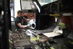 a man working on a car in a garage