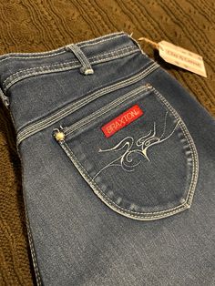 "Vintage Medium Dark Wash High Waisted Straight Leg Braxton Stretch Denim Jeans with pocket embroidery design  Brand: Braxton Size on Tag: 16 Country of Origin: Malaysia Material: 43% cotton - 29% rayon - 28% polyester  Measurements: Waist - 32\"  Inseam - 29\"  Leg Opening - 14\"  Universal Standard Size: 10-12 Weight: 1 lb 5.7 oz SKU: DJ110 Disclaimer:  All items are second hand and may have imperfections or modifications, however they are inspected for quality and may have been mended or treated for stains. All items are washed with plant based hypoallergenic detergent and measured for accurate and inclusive sizing standards. The size on the tag and the Universal Standard Size may differ. Refer to the sizing chart provided and measure your body to find the most comfortable fit." Universal Standard, Vintage Sportswear, Jean Vintage, Stretch Denim, Denim Jeans, Straight Leg, Comfort Fit, Embroidery Designs, Branding Design