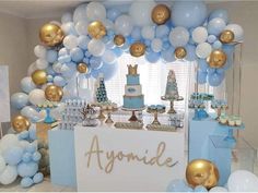 a blue and gold birthday party with balloons, cake, cupcakes and decorations