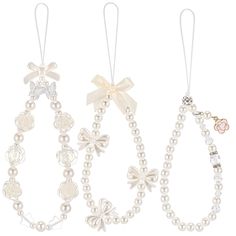 three necklaces with bows and pearls on them